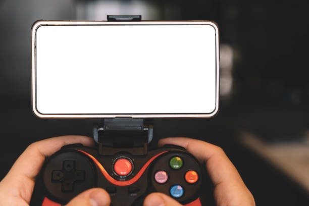 istock Game Pad with smartphone in hands isolated on black background. Mobile Gaming concept. a blank white screen on a smartphone for copy space. 1474829481