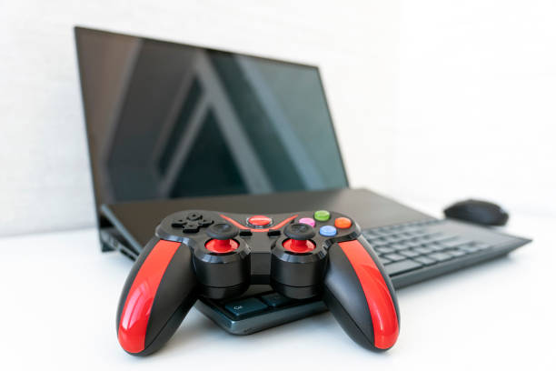 istock gamer work space concept, top view gaming gear, keyboard, joystick, mouse and headset white table background. 1474829489