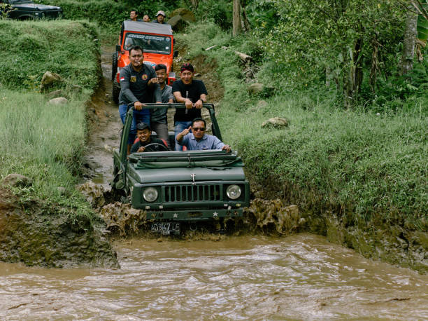 Solo, Indonesia - 2023: Jeep Wrangler crosses a river