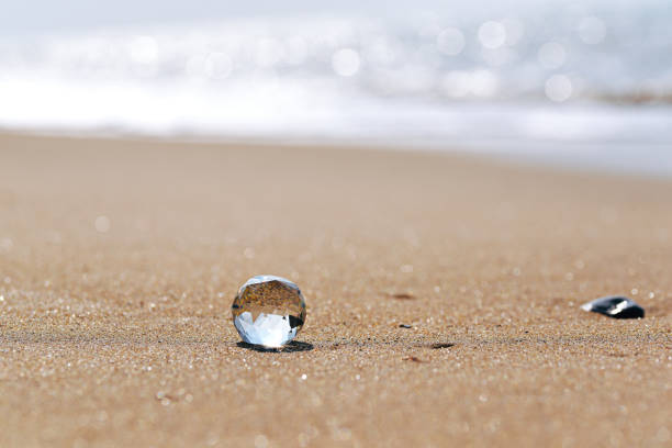 Crystal lies on the sandy sunny seashore.