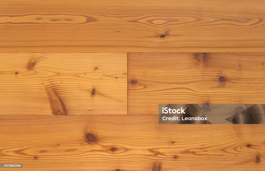 Close-up of a polished larch board (parquet flooring made of larch wood with the typical yellow-orange coloration). Parquet Floor Stock Photo