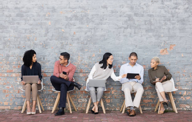 istock Diversity, worker interview line and discussion with technology for meeting, recruitment or company hiring. Human resources, happy employees and speaking together on laptop, tablet or smartphone 1474833611