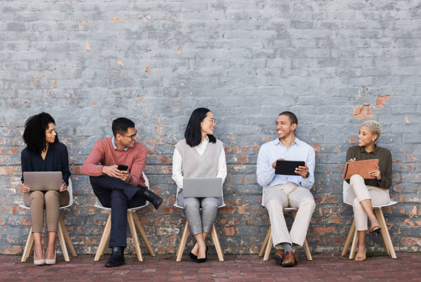 istock Employee diversity, interview line and conversation with technology for meeting, recruitment or company hiring. Human resources, happy business people and discussion with laptop, tablet or smartphone 1474833612