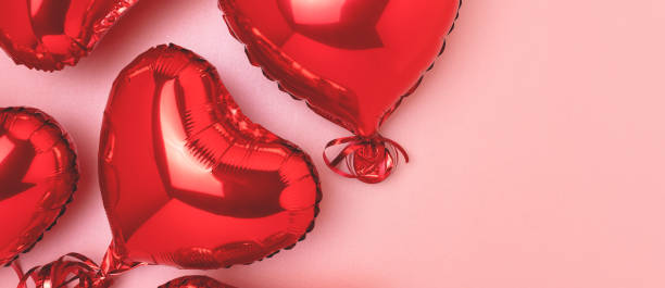 istock Banner with red inflatable foil balloons in a heart shape. 1474834415