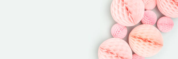 istock Banner with pink tissue paper balls different sizes on a blue background. 1474834905