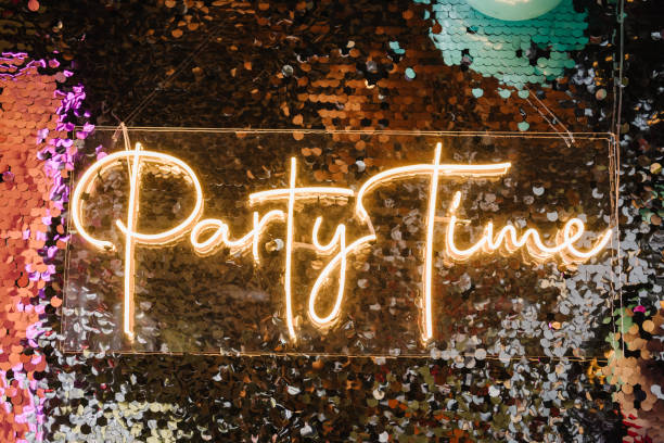 istock Silver photo booth with decor shiny and led strips with text party time. Zone with sparkling sequins. Glitter festive wall for wedding. A place for congratulations on birthday. Happy New Year 2024. 1474834952