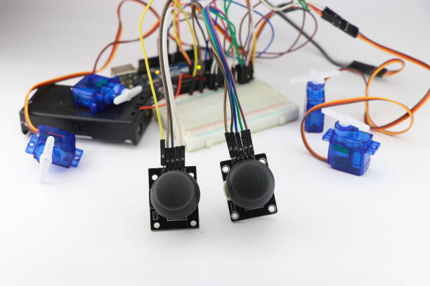 istock Joystick modules control the micro servos circuit made on a breadboard with jumper wires. Electronics used in diy product engineering 1474836429