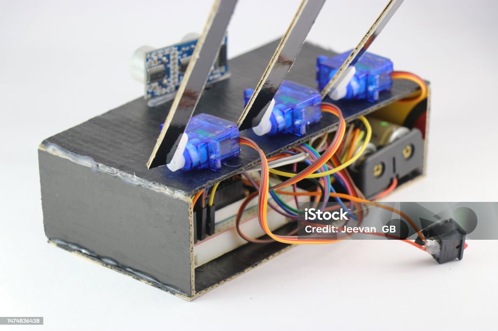 Micro servos or plastic servo motors are connected to a breadboard and micro controller using jumper wires in an interactive electronics project Brand Name Video Game Stock Photo