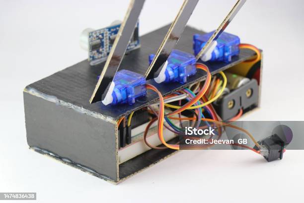 Micro Servos Or Plastic Servo Motors Are Connected To A Breadboard And Micro Controller Using Jumper Wires In An Interactive Electronics Project Stock Photo - Download Image Now