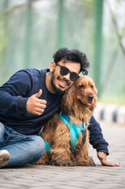 istock Guy and his dog having a fun in the nature 1474836536