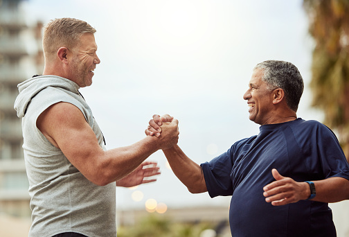 Old man, fitness and people handshake for health, lose weight or wellness thank you, support and accountability training, exercise or workout. Community friends, sports trust or teamwork hands sign
