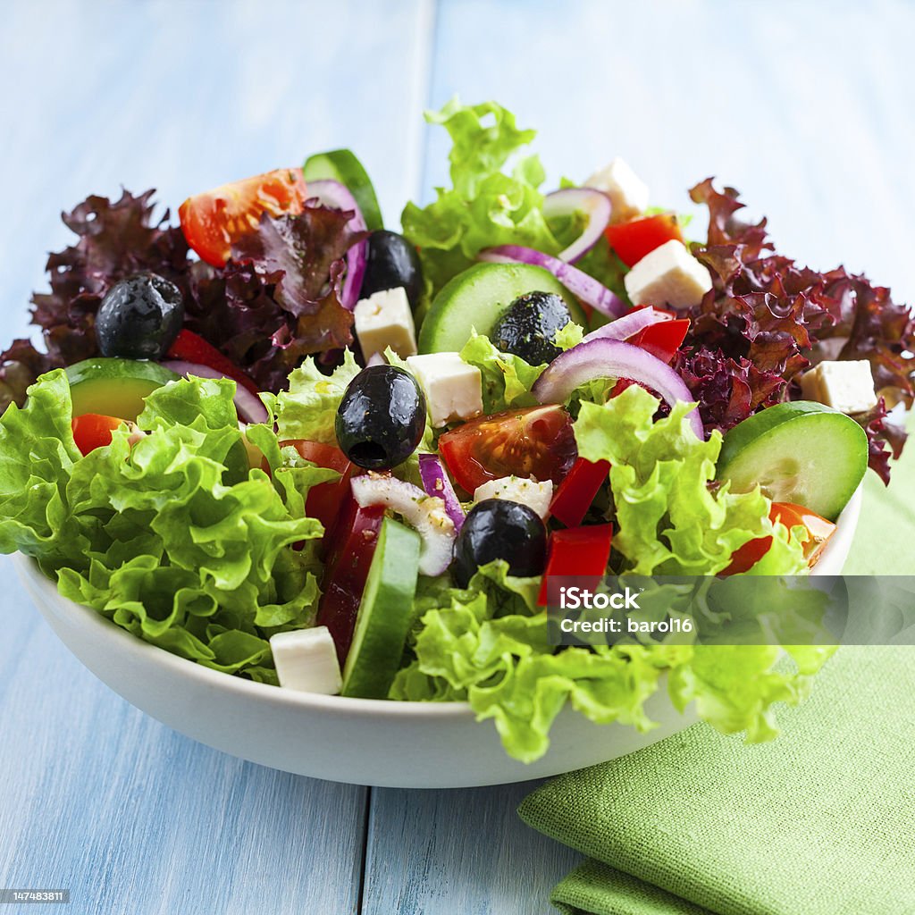 Greek Salad greek salad with green and red lettuce in a bowl Appetizer Stock Photo