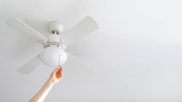 istock person turn on electric ceiling lamp with propeller indoors 1474838420