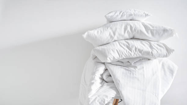 dirty bedclothes and pillows, preparing for washing