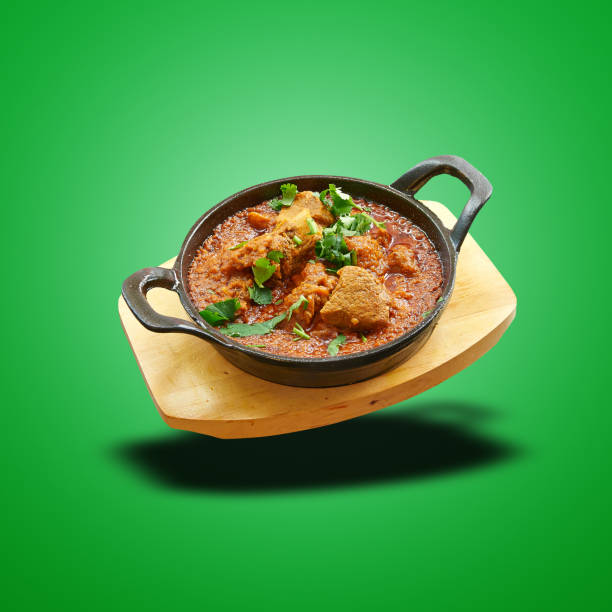 istock Floating lamb karahi baked in little pan on green 1474838687