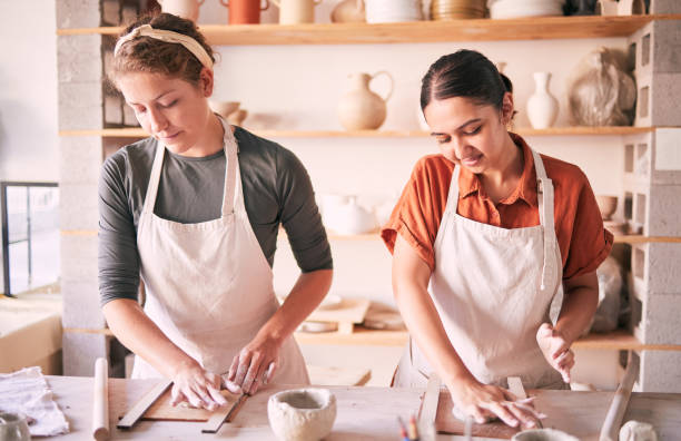 istock Pottery, art and women in workshop class for molding clay, working on artistic bowl or ceramic. Creative, ceramics manufacturing or females in studio, startup or small business for designing crockery 1474838841