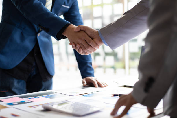 Business partner handshake after the meeting. Financial and investment cooperation. Business partner handshake after the meeting. Financial and investment cooperation. business consultation stock pictures, royalty-free photos & images