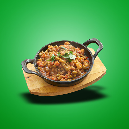 Floating Vegetable baked in little pan on green gradient background