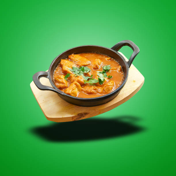 istock Floating Chicken curry baked in little pan on green 1474839061