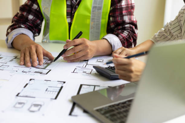 istock Architect and engineer colleagues brainstorm design work on blueprint planning ideas of construction projects. Construction engineering design inspector team. 1474839108