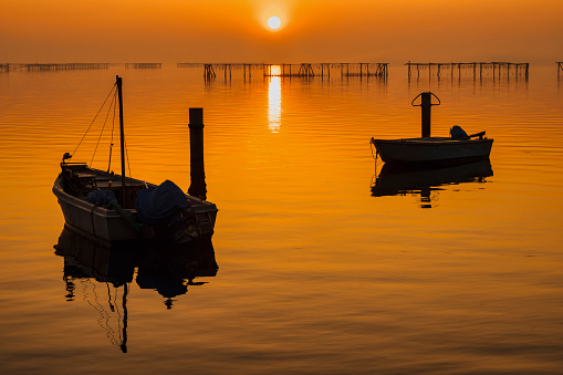 views of the fishing village laying on the shore of the Scardovary bay during a winter sunset, porto Tolle, Rovigo