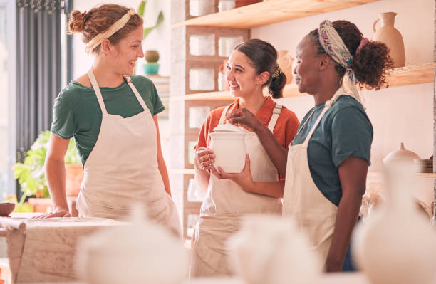 istock Communication, pottery workshop class or women design sculpture mold, manufacturing or art product. Diversity, ceramic retail store or startup small business owner, artist or people talking in studio 1474840590