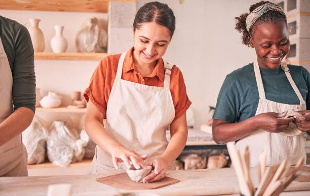 istock Pottery class, group workshop or happy people design sculpture mold, clay manufacturing or art product. Diversity, ceramic retail store or startup small business owner, artist or studio women molding 1474840603