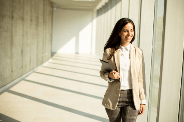 istock Young businesswoman walking on modern office hallway 1474842209