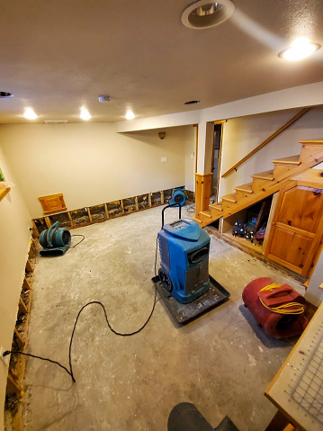Here we see and few air movers and a dehumidifier drying out a basement after a water mitigation crew removed some carpet and preformed a flood cut on the walls.