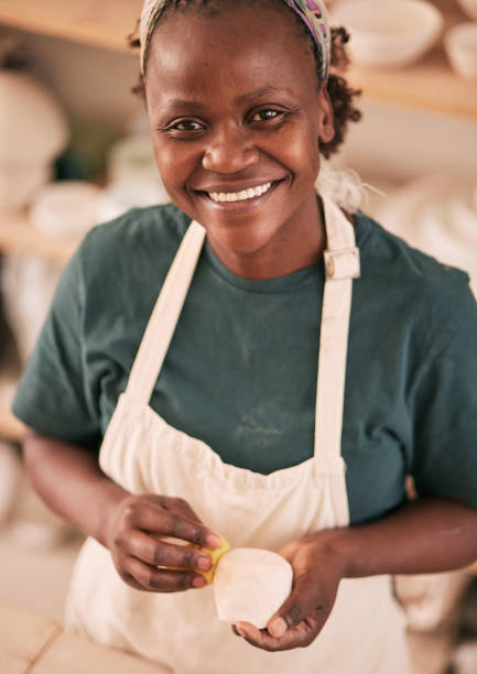 istock Art, pottery and black woman in creative workshop with ceramics, sculpting and creativity with smile in portrait. Artist with handmade craft, pride and success with manufacturing and artistic process 1474843003