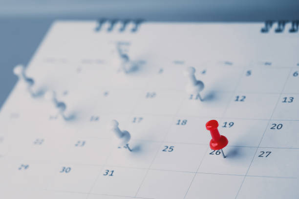 istock Embroidered red pins on a calendar event Planner calendar,clock to set timetable organize schedule,planning for business meeting or travel planning concept. 1474843100