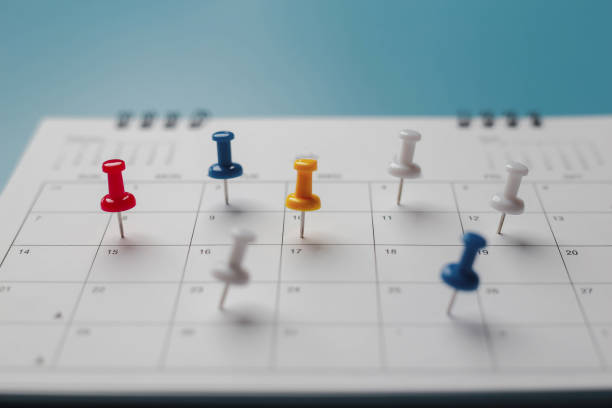 istock Embroidered red pins on a calendar event Planner calendar,clock to set timetable organize schedule,planning for business meeting or travel planning concept. 1474843130