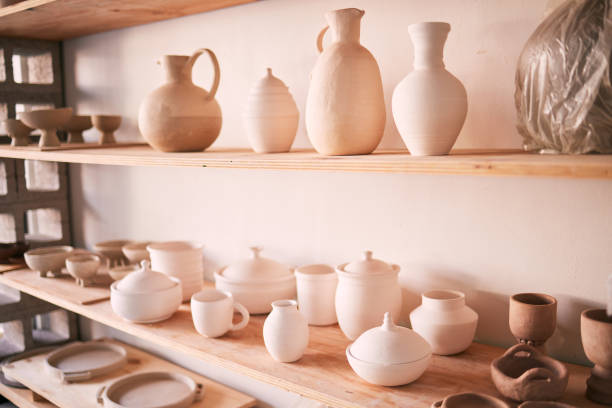 istock Ceramics, dishes and pottery on shelf in studio, creative store and manufacturing startup. Clay products, background and shelves in workshop, small business and retail craft shop of stock production 1474844203