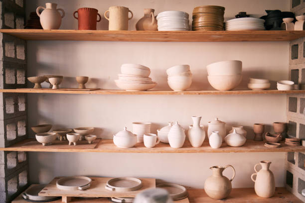 istock Pottery backgrounds, ceramics and shelf in studio, creative store or manufacturing startup. Clay products, collection and display in workshop, small business and retail craft shop of stock production 1474844210