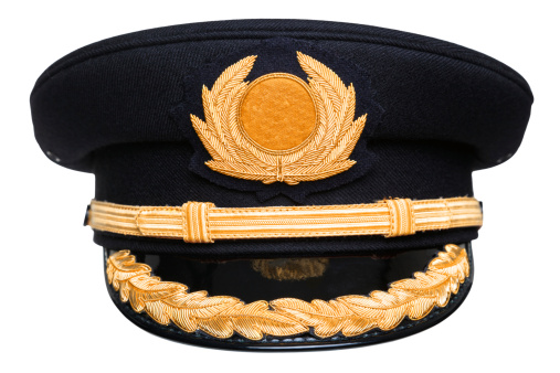 Photo of an airline pilots hat or cap with gold insignia, isolated on a white background with clipping path.