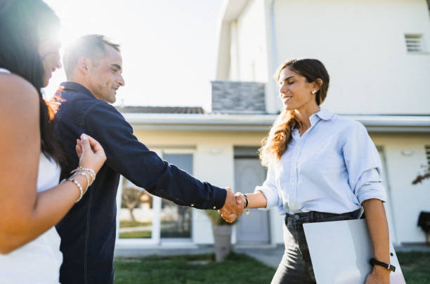 istock real state agent showing the new house 1474845882