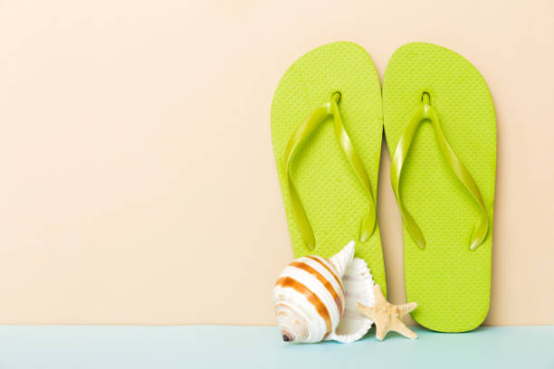 istock Beach accessories. Flip flops and starfish on colored background. Mock up with copy space 1474846073