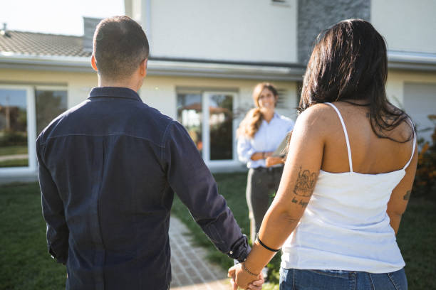 istock real state agent showing the new house 1474846240