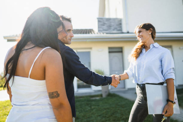 istock real state agent showing the new house 1474846297