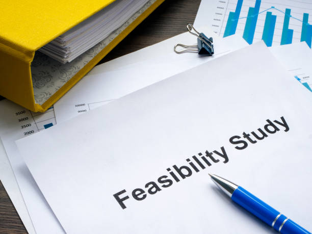 Stack of papers with feasibility study and folder. stock photo