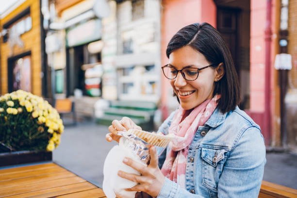 istock Young woman eating gyros 1474848193