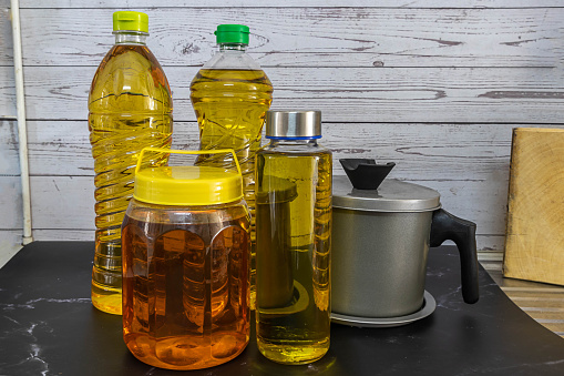 Vegetable or cooking oil in various containers.