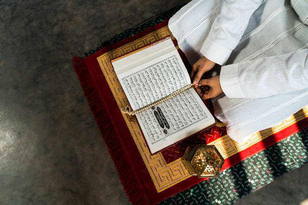 istock Reading Quran top view with Traditional Ramadan Lantern lamp 1474850712