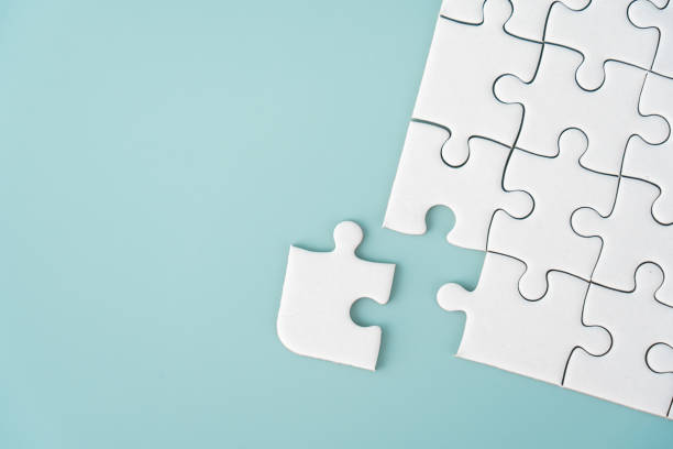 istock White jigsaw puzzle background for business concept of strategy solution 1474850714
