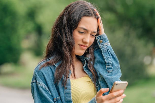istock girl looking at the mobile phone sad or distressed 1474850810