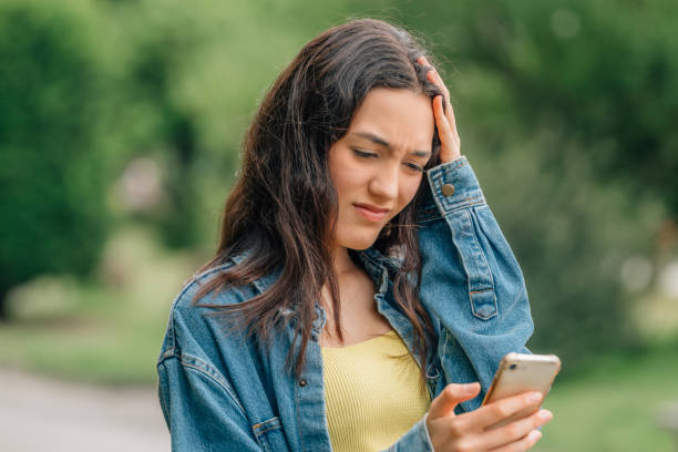 istock girl looking at the mobile phone sad or distressed 1474850812