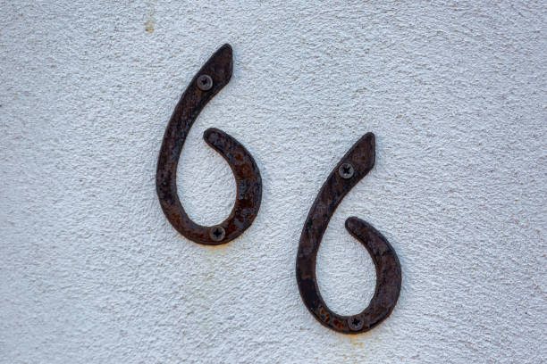 istock Old Weathered House Number 66, Metal on Wall 1474850860