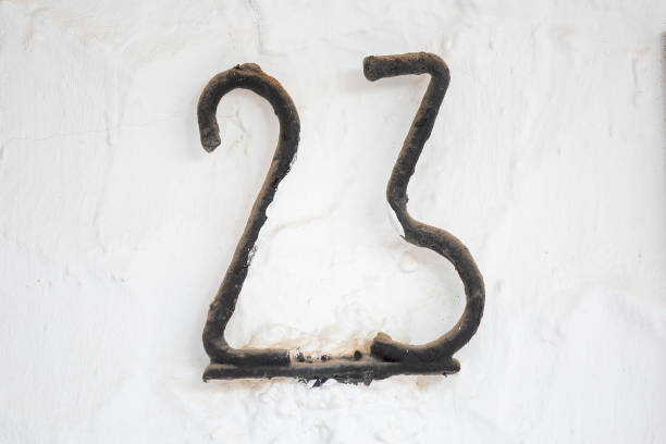 istock Old Weathered House Number 23, Metal on Wall 1474850943