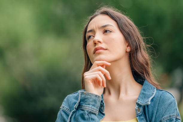 istock thoughtful girl making decision or expression of doubt 1474850947