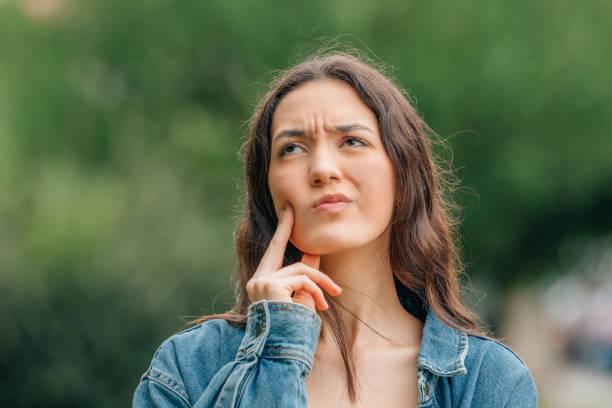 istock thoughtful girl making decision or expression of doubt 1474850954